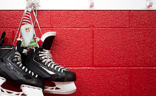 hockey skates hanging on a wall